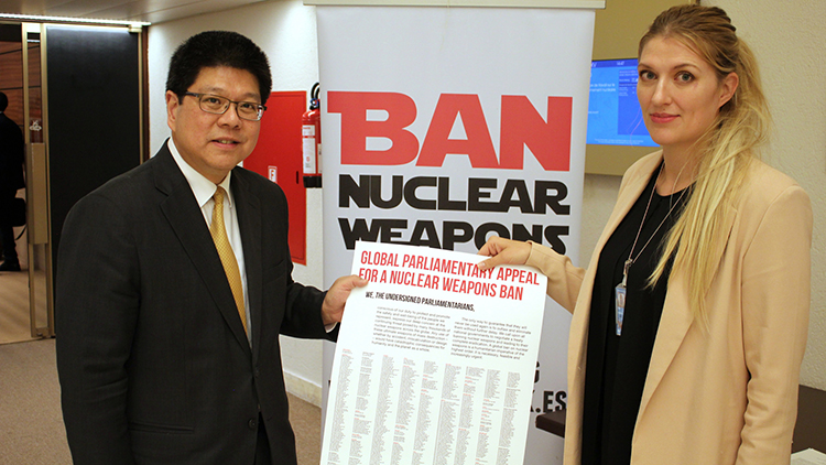 Man and woman holding nuclear agreement.