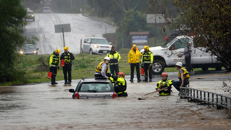rescue workers on a flooded street
