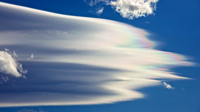 wispy cloud with thin green, blue, purple, and orange streaks on its edges