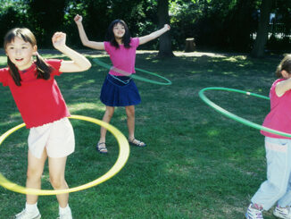 Children spinning a toy hoop around their waists